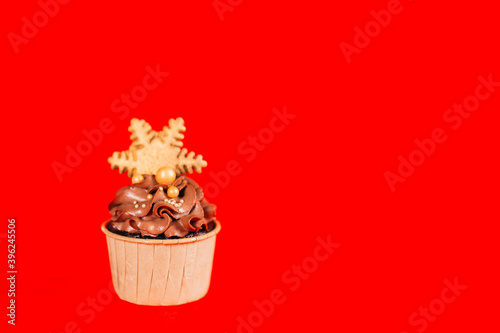 Chocolate cupcakes with star-shaped cookies on a red background. Christmas mood. Sweets for any occasion