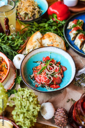 Wallpaper Mural Muslim Ramadan iftar family dinner. Flat-lay of people feasting over table with Middle East food. Dates, dolma, kebab, flatbread, pide, borek, sweet, salad, top view. Ramazan fasting Turkish cuisine. Torontodigital.ca