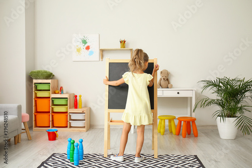 Cute little girl drawing on...