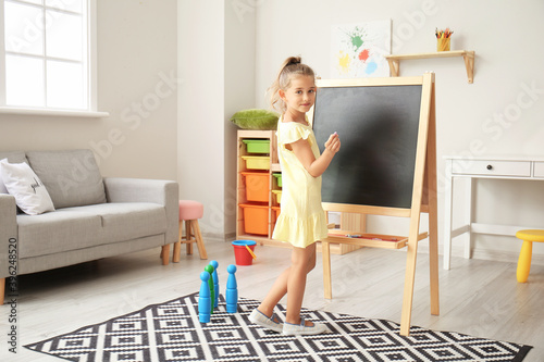 Cute little girl near black...