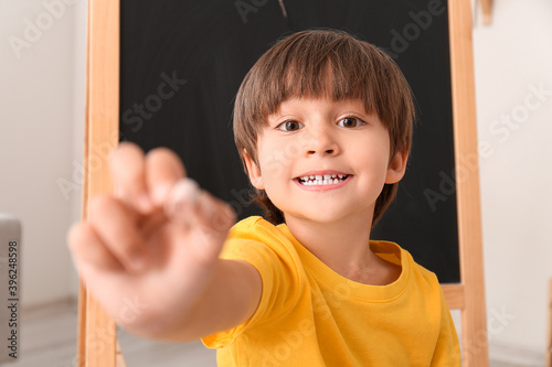 Cute little boy with chalk ...