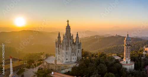 Aerial drone view of Basilica Sacred Heart on Mount Tibidabo near Barcelona during sunset golden hour photo
