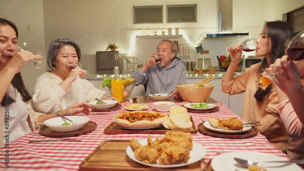Asian big family clinking wine glasses together in the happy moment. Asian big family clinking wine glasses together in the happy moment.