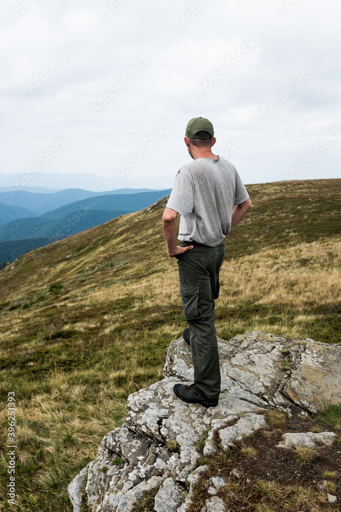 Hiker Man in a summer mountains. Trekking and outdoor concept. Hiker Man in a summer mountains. Trekking and outdoor concept.
