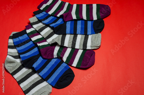 Striped socks against a red background.