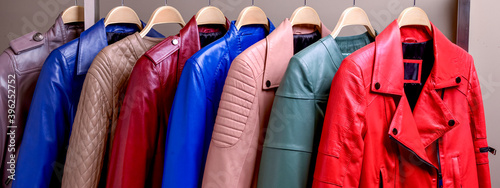 New collection of different color spring leather jackets for women. Colorful background of modern outerwear.