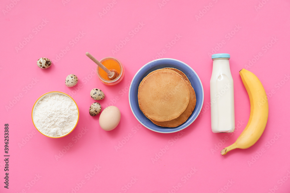 Tasty banana pancakes with ingredients on color background Tasty banana pancakes with ingredients on color background