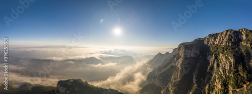 Panoramic aerial drone shot of morning clouds over Montserrat mountain near Barcelona photo