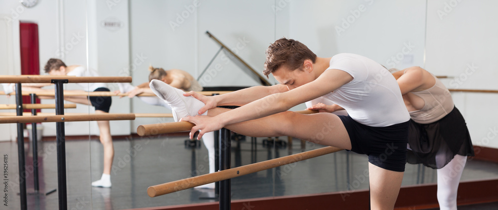 Teenager and women practicing at the ballet barre. High quality photo