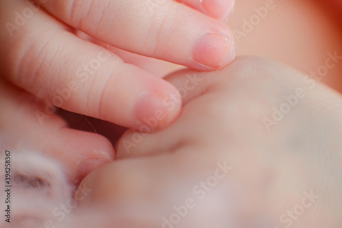 Caucasian Newborn baby hand closeup macro detail shot. child portrait, health skin, tenderness, maternity and babyhood concept - Image. Soft selective focus