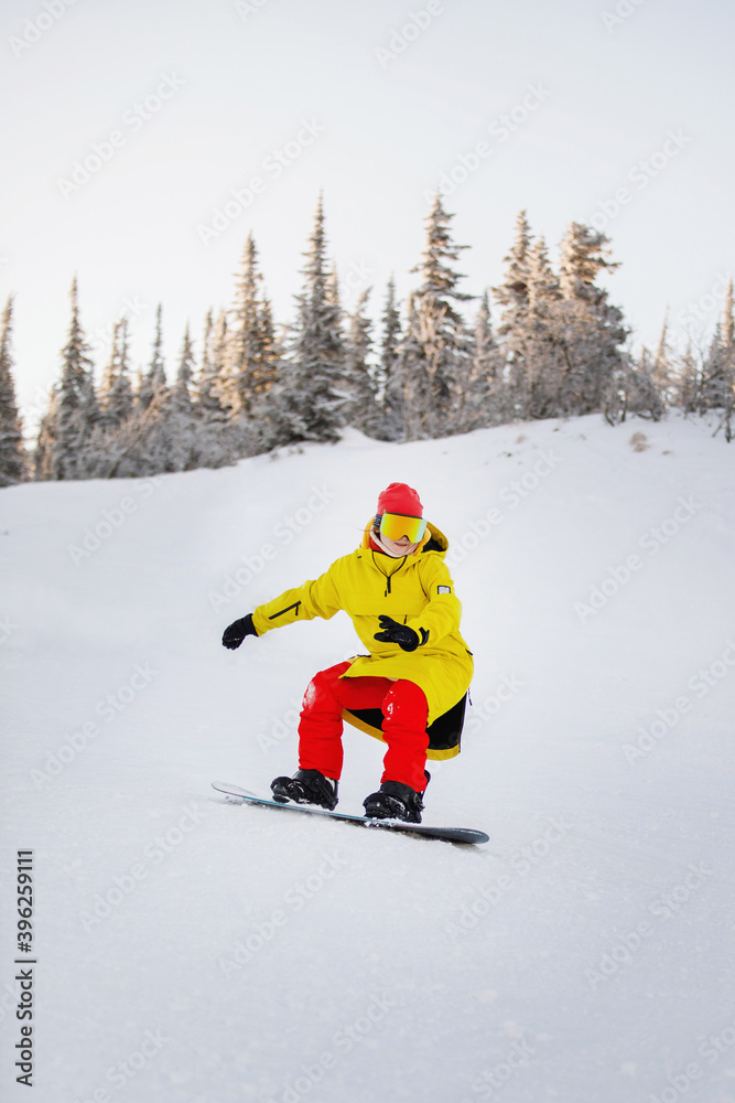 Woman is snowboarding on the snowy slopes. Woman is snowboarding on the snowy slopes.
