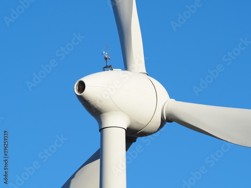 Fragment of a wind turbine against a blue background.