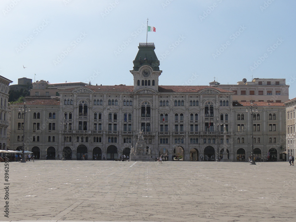 Naklejka premium Town Hall building in Piazza Unità d'Italia in Trieste, exterior with eclectic style and the fountain of the Four Continents in front