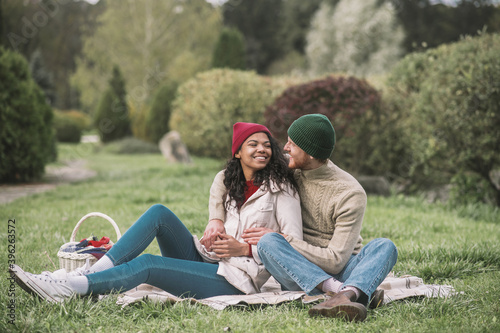 Happy couple having a family picnic in the park