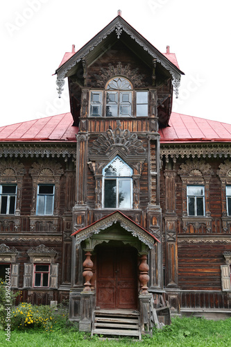 Pogorelovo terem. Ancient wooden house with carved windows, ornamental frames in Pogorelovo village, Chukhloma, Kostroma region, Russia. Traditional russian style, old architecture. Kostroma landmark photo