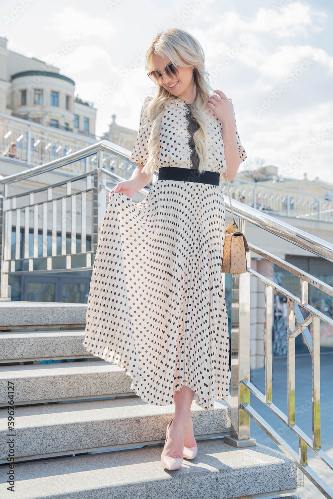 Cute young woman wearing a long dress posing Cute young woman wearing a long dress posing