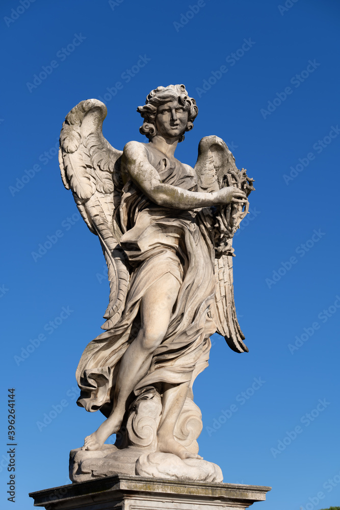 Angel with the Crown of Thorns on Ponte Sant Angelo bridge in Rome, Italy. Marble sculpture from 17th century by Naldini, design of Bernini