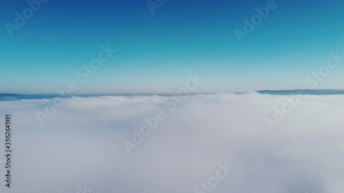 Flying over clouds, birds flying over.