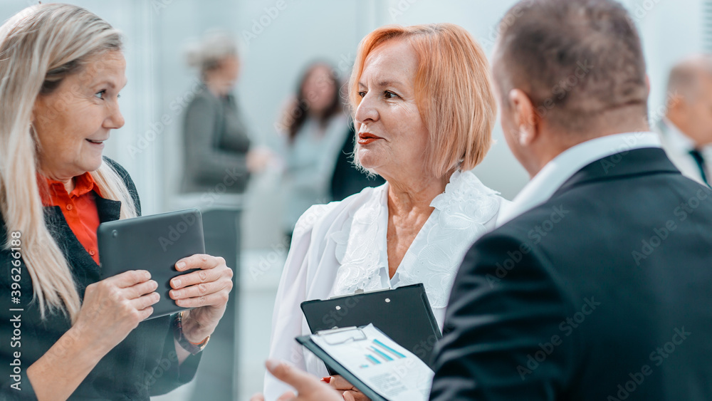 close up . competent businesswoman talking to her colleague. close up . competent businesswoman talking to her colleague.