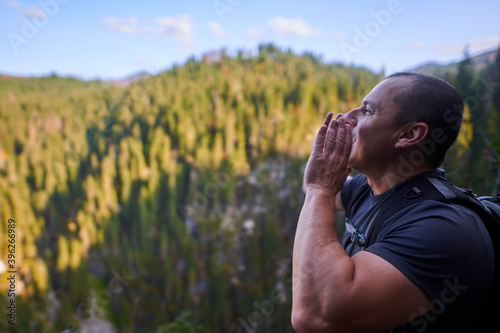 Hiker shouting to hear echo photo