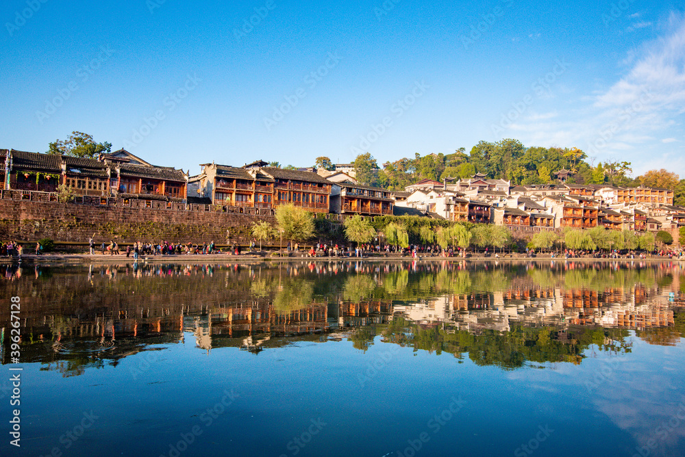 the river, the boat, stone bridge and the old houses at ancient phoenix town in the morning at Hunan, China. the river, the boat, stone bridge and the old houses at ancient phoenix town in the morning at Hunan, China.
