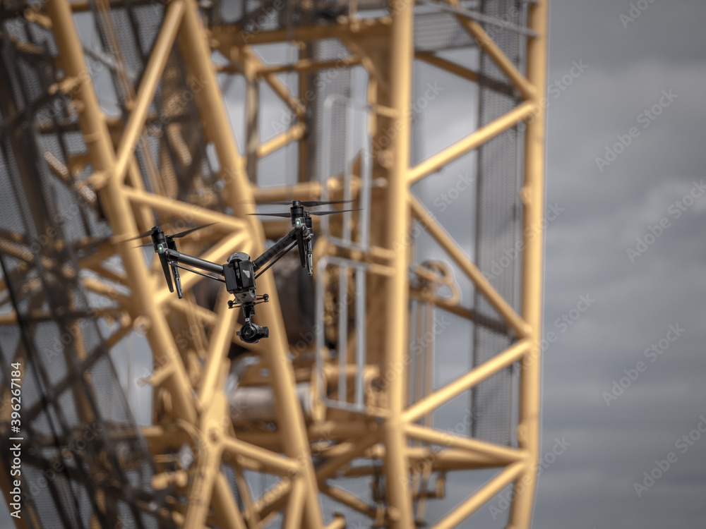 Fototapeta premium drone flies for inspection in front of a huge crane