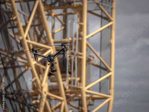 drone flies for inspection in front of a huge crane