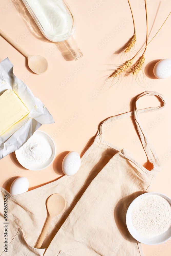 Raw ingredients for baking on the beige table, top view background Raw ingredients for baking on the beige table, top view background