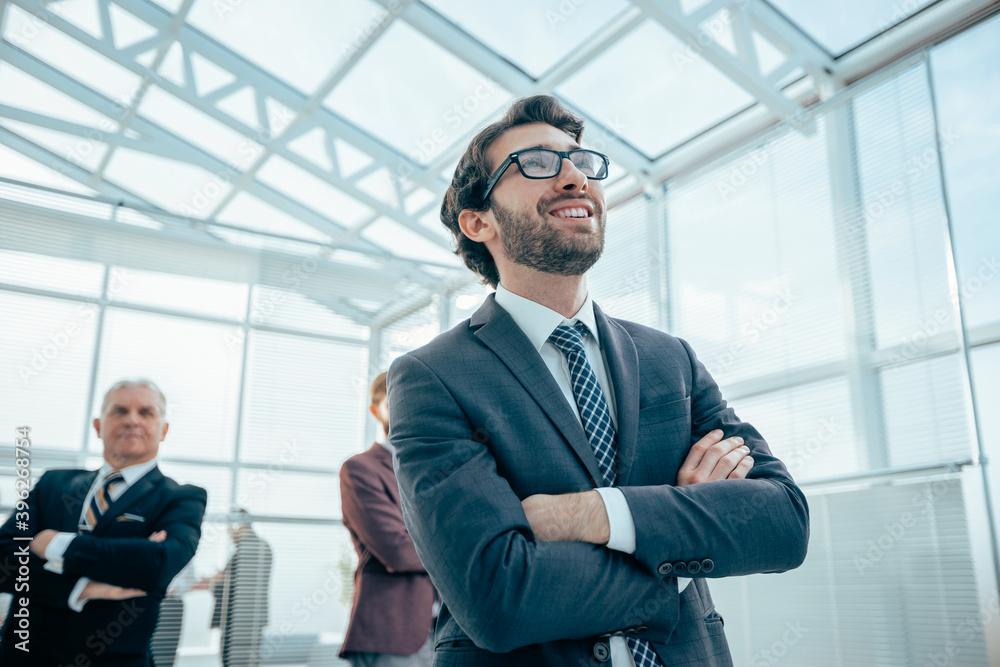 confident business man standing in a modern office confident business man standing in a modern office