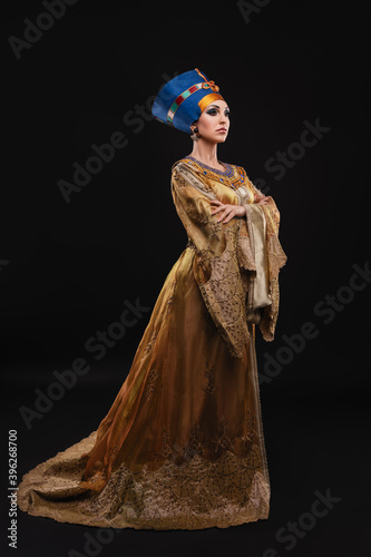 studio portrait of a beautiful woman with brown eyes and evening make-up in t...