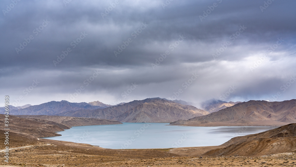 Scenic landscape view of high-altitude Yashilkul lake in the Pamir mountains of Gorno-Badakshan in Tajikistan on an overcast day