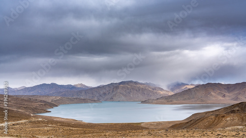 Scenic landscape view of high-altitude Yashilkul lake in the Pamir mountains of Gorno-Badakshan in Tajikistan on an overcast day