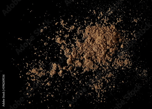 Organic linseed protein powder pile isolated on black background