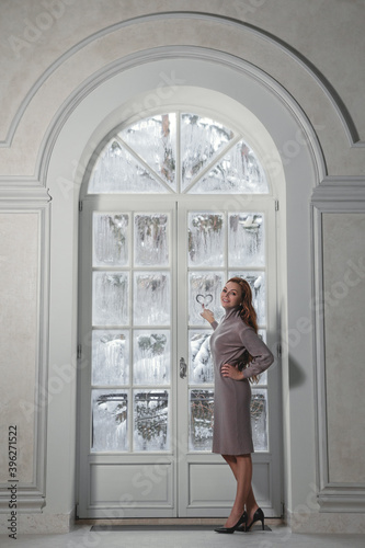 Woman next to winter window