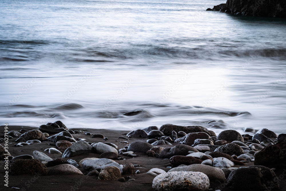 Naklejka premium Calm waves touching beach stones on Madeira island