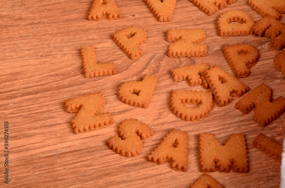 Gingerbread letters cookies on a brown wooden background Gingerbread letters cookies on a brown wooden background