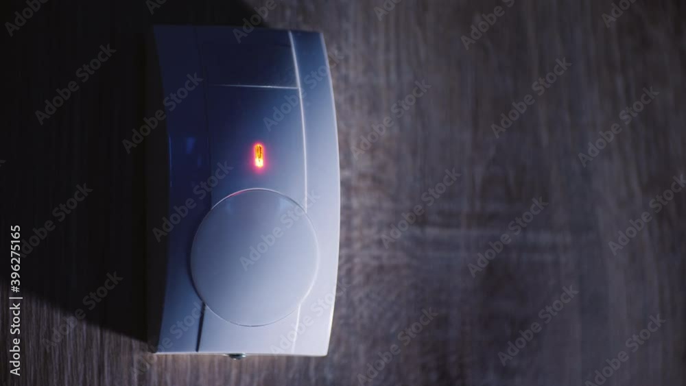 At dusk on the wall of the house triggered infrared motion sensor