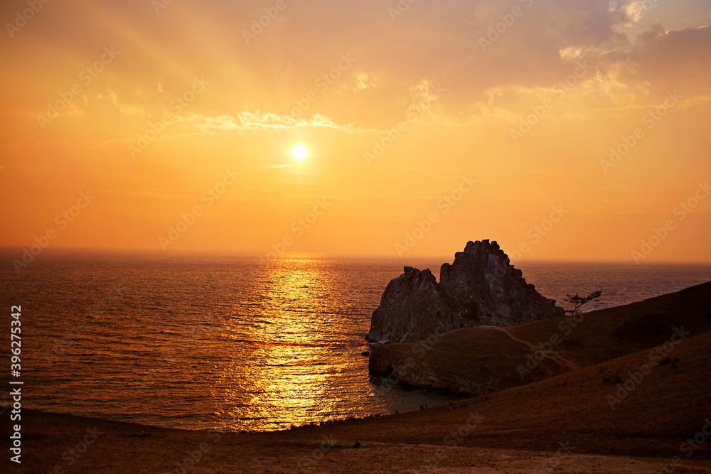 Colorful sunset on lake Baikal. Olkhon island on a summer evening. Cape Burhan or Shamanka rock 
