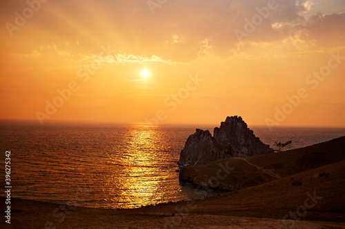 Colorful sunset on lake Baikal. Olkhon island on a summer evening. Cape Burhan or Shamanka rock 