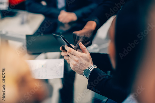 close up. employees using their smartphone to view new information.