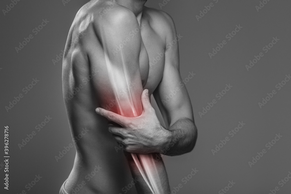 Naklejka premium Arm pain, the person is holding the painful elbow