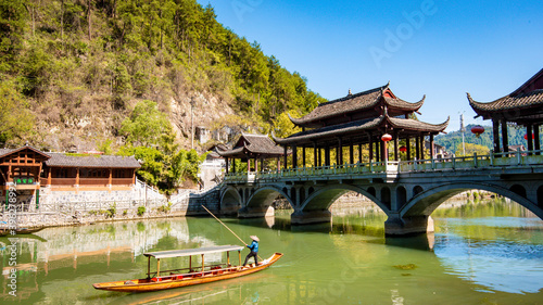 the river  the boat  stone bridge and the old houses at ancient phoenix town in the morning at Hunan  China.