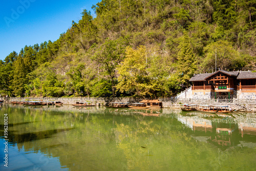 the river, the boat, stone bridge and the old houses at ancient phoenix town in the morning at Hunan, China.