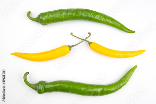 yellow, and green hot chili on a white plate. Pepper. Vegetable vitamin food.