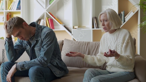 Konstfotografi Angry aged mother quarreling, arguing with son, bad family relationships concept