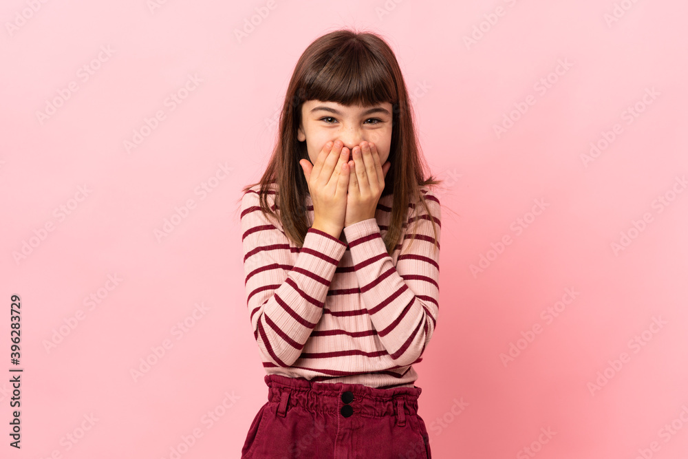 Little girl isolated on pink background happy and smiling covering mouth with hands Little girl isolated on pink background happy and smiling covering mouth with hands