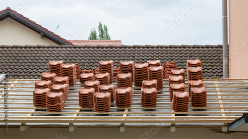 Stacks of roof tiles on a roof under construction. Symbol for roofer as a profession or the building construction industry.