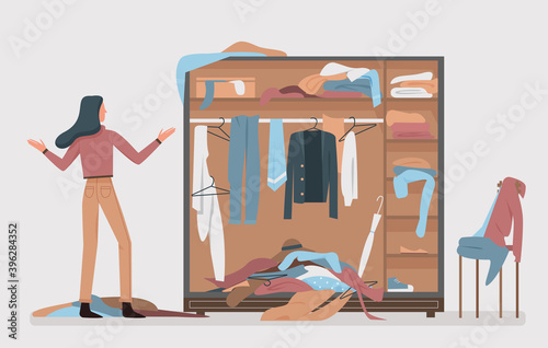 Messy closet, dressing home room interior vector illustration. Cartoon woman worried about mess in open wardrobe, standing next to pile of thrown clothes, untidy clutter fashion clothing background
