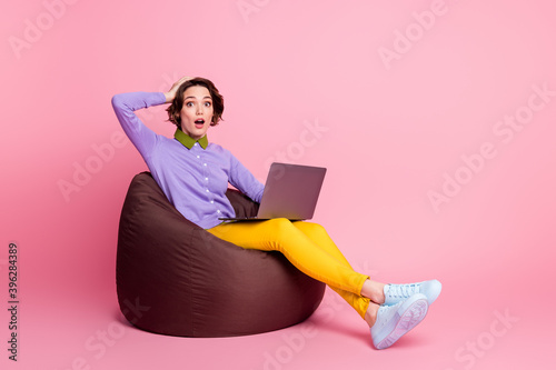 Full body profile side photo frustrated girl sit bean chair work laptop wear pants isolated pastel color background
