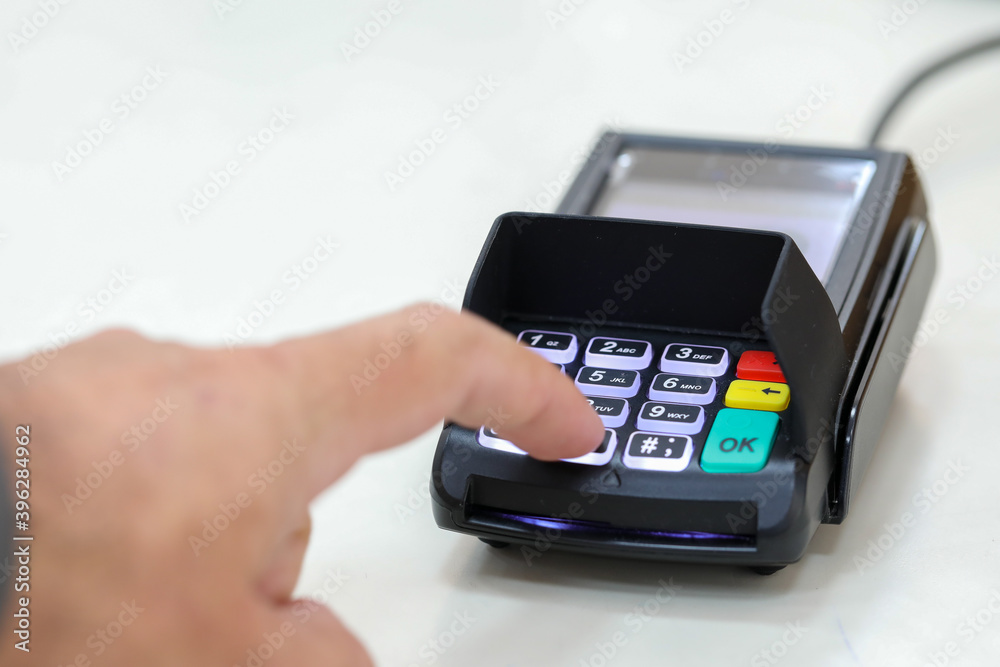 Finger clicks on a transaction confirmation at a credit card payment terminal. Finger clicks on a transaction confirmation at a credit card payment terminal.